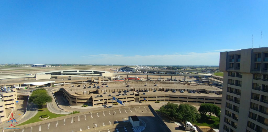 a parking lot with many cars and buildings