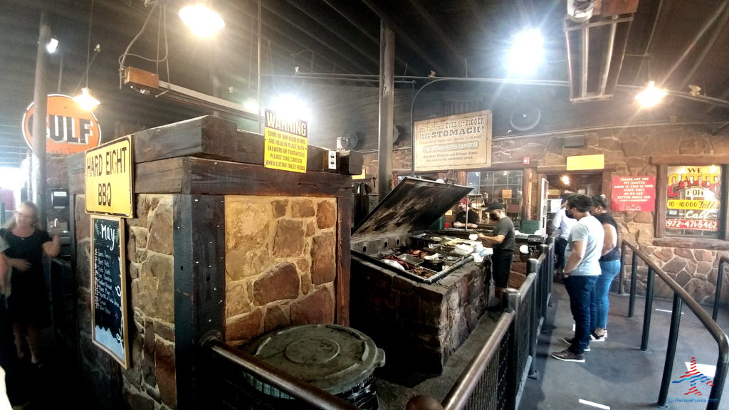 a large room with a large grill and people standing around