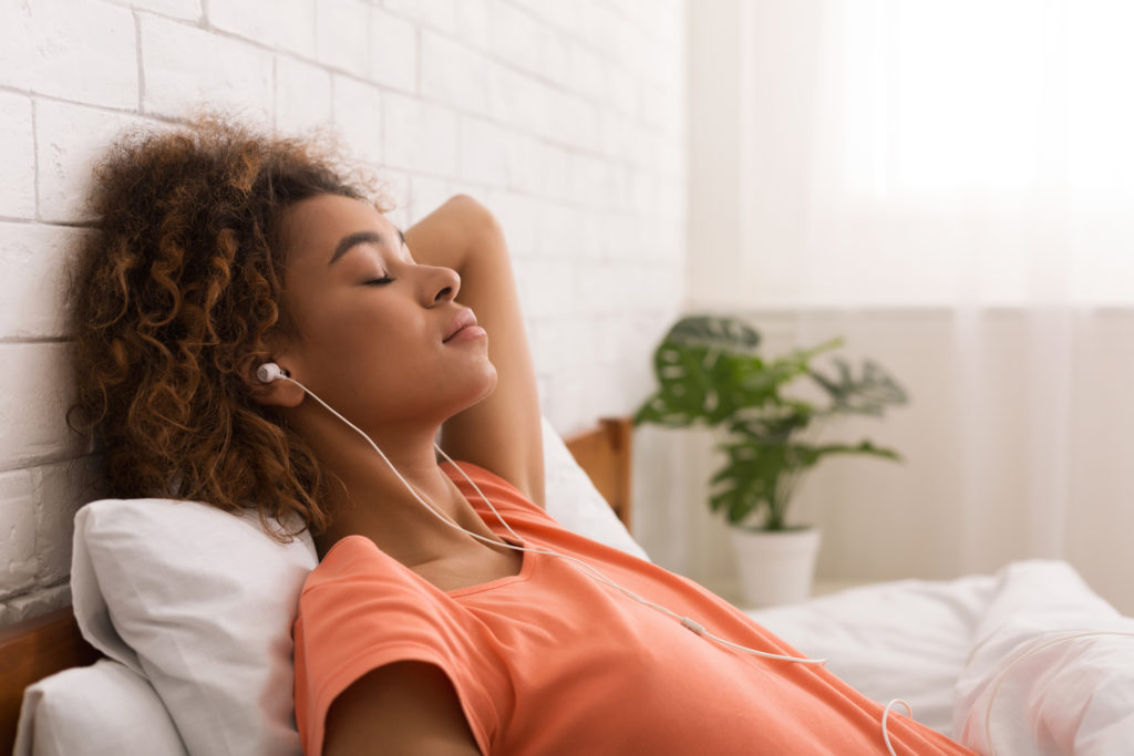 A woman relaxes while listening to music