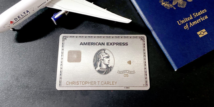 Delta Air Lines plane and a passport flank a Platinum Card® from American Express -- a product which earns Membership Rewards points.