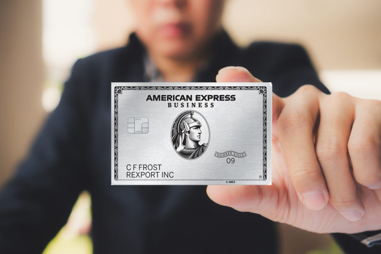 Businessman holding a Business Platinum Card® from American Express