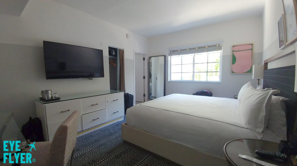 a bedroom with a tv and a bed