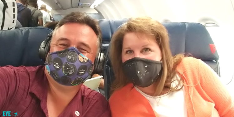a man and woman wearing face masks