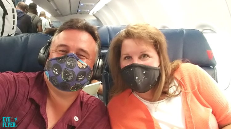 a man and woman wearing face masks