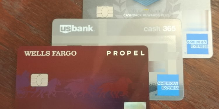 a group of credit cards on a wood surface