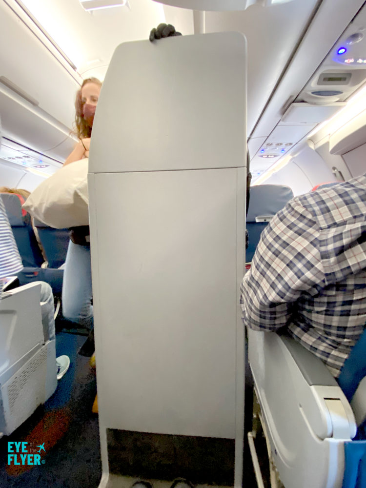 A flight attendant's jumpseat is seen in a Delta Air Lines A321 aircraft. This image was taken from seat 14D is in Delta’s Comfort+ service class.