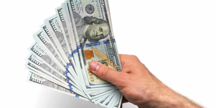 A handful of money: $100 (hundred dollar) bills