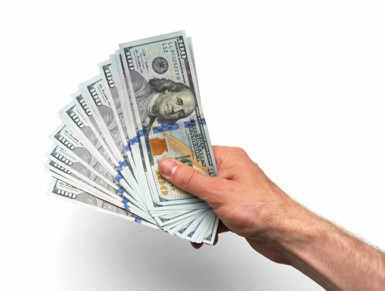 A handful of money: $100 (hundred dollar) bills