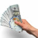 A handful of money: $100 (hundred dollar) bills