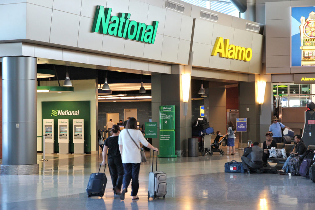 Alamo and National car rental airport office in Las Vegas. Both brands are owned by Enterprise Holdings, company employing 74,000 people (2013).