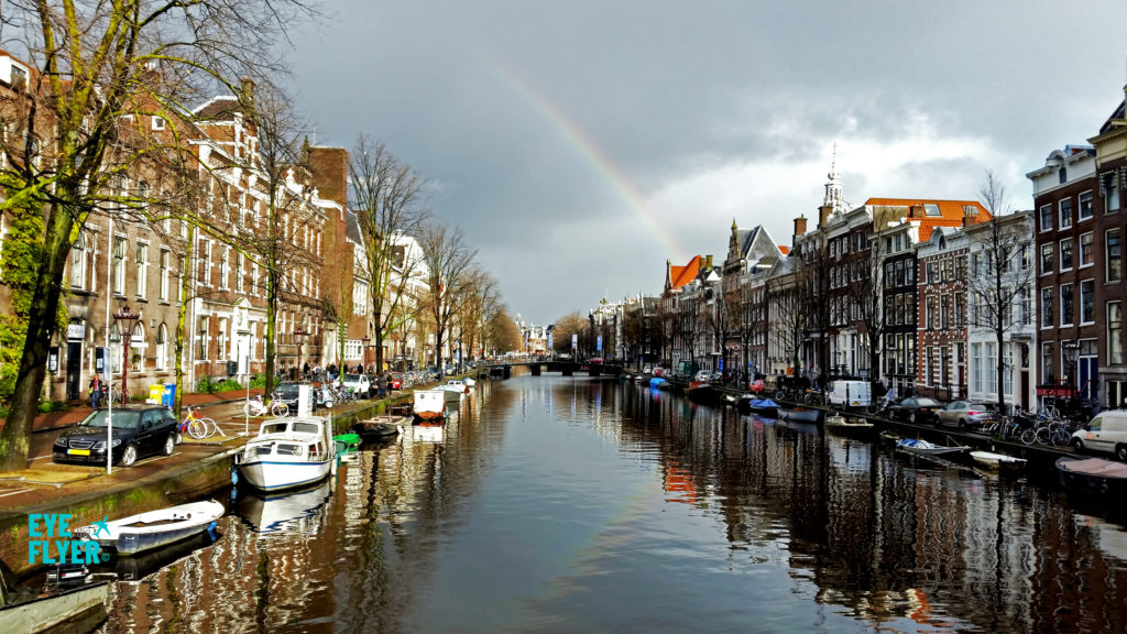 A rainbow is seen over a canal in Amsterdam.