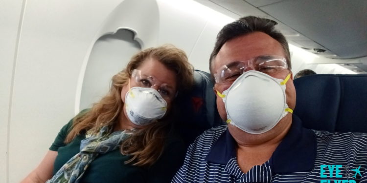 a man and woman wearing face masks
