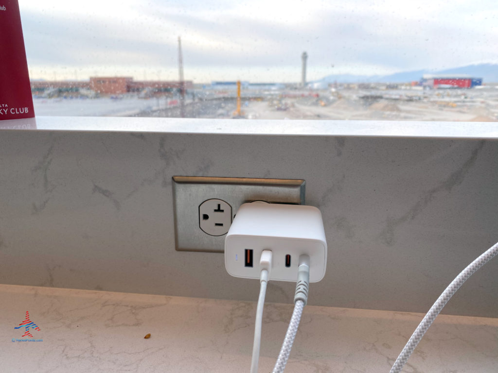 An AUKEY Omnia 100W USB-C and USB-A charger are used during a visit to the Delta Sky Club Salt Lake City inside Terminal A of Salt Lake City International Airport (SLC). (Photo ©RenesPoints.com)