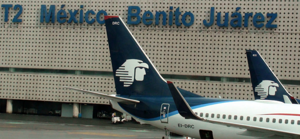 View Of Airport Ground Staff Unloading Passengers Bag From Aero Mexico Airlines Airplane After Arrival At Loading And Unloading Gate Of Benito Juarez Airport In Mexico City Mexico (©iStock.com/LIVINUS)