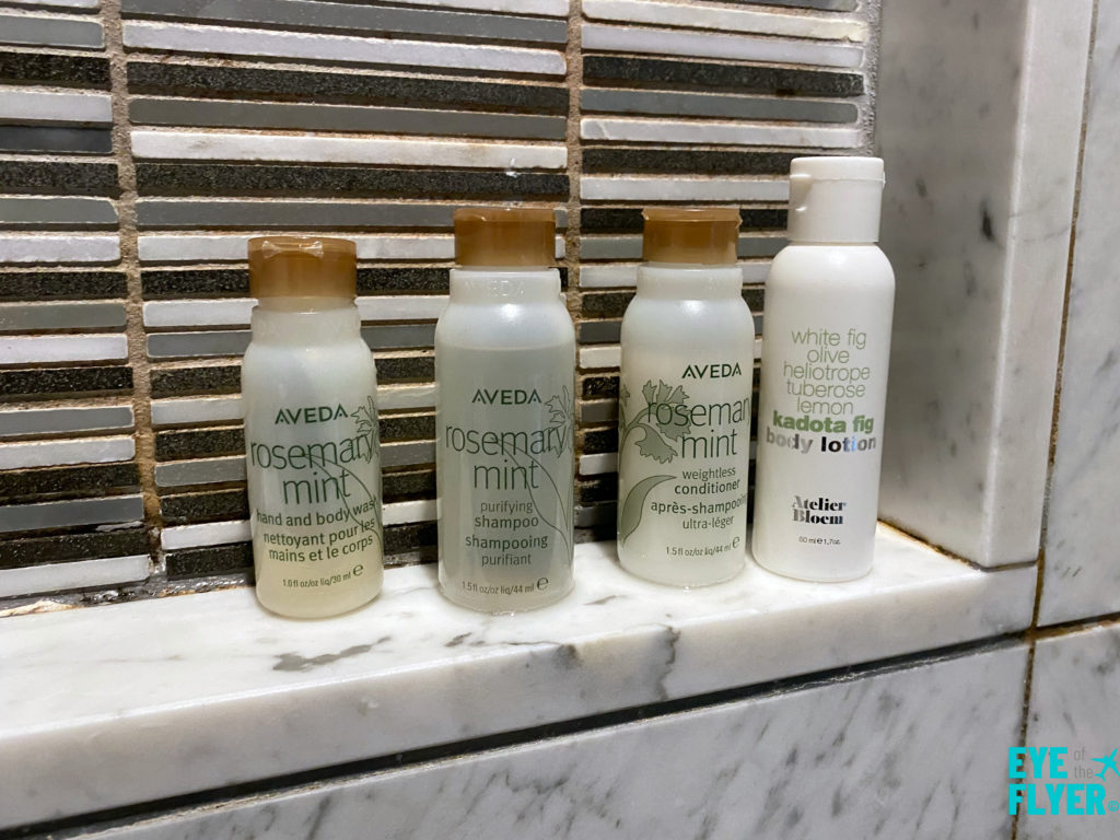 Aveda toiletries provided in the shower in bathroom inside a King Premier Room at the Kimpton Muse Hotel near Times Square in New York