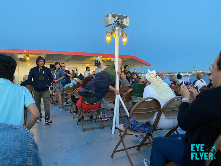 Tour guide David shows off his strength during a Circle Line Harbor Lights Cruise.
