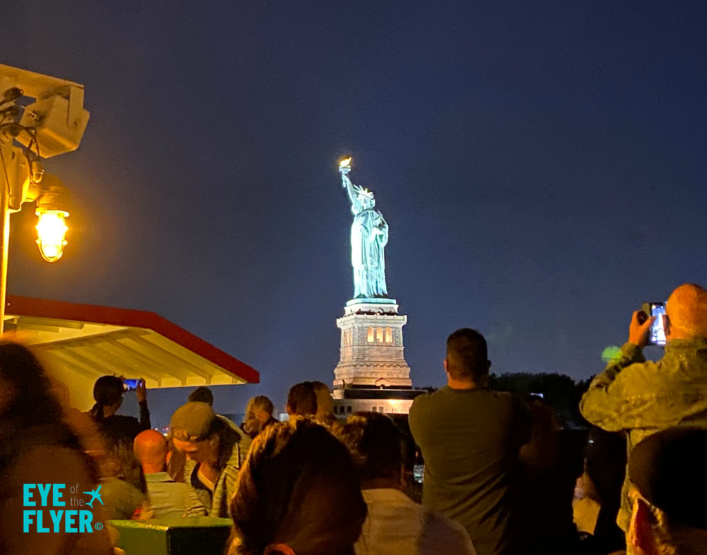 The Statue of Liberty is seen at night during a Circle Line Harbor Lights Cruise.