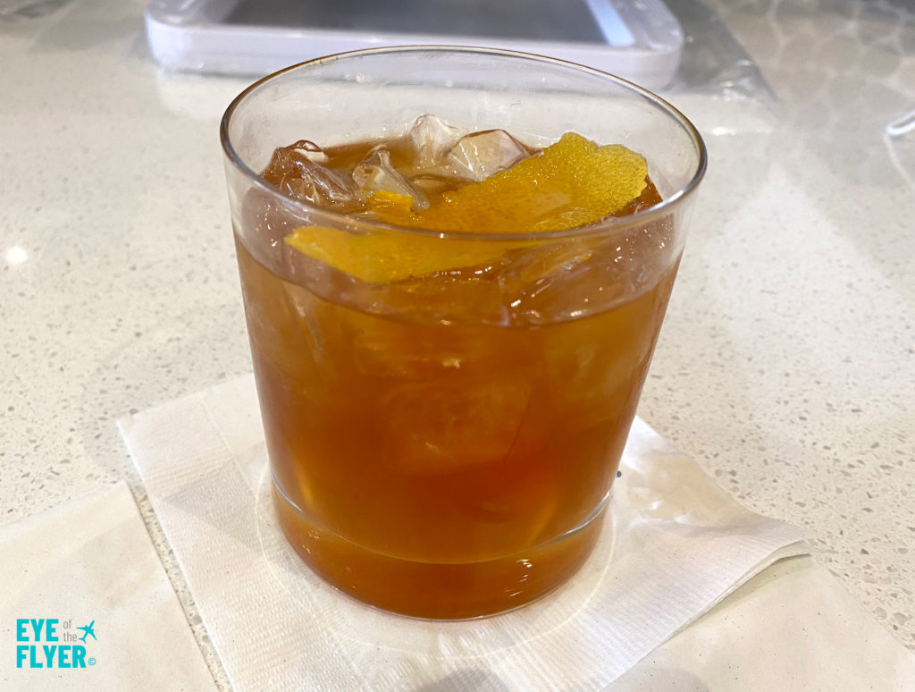 A Peanut Butter Old Fashioned is displayed inside the Newark (EWR) Delta Sky Club.