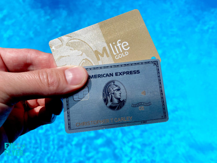 MGM Resorts M Life card and a Platinum Card® from American Express against a swimming pool
