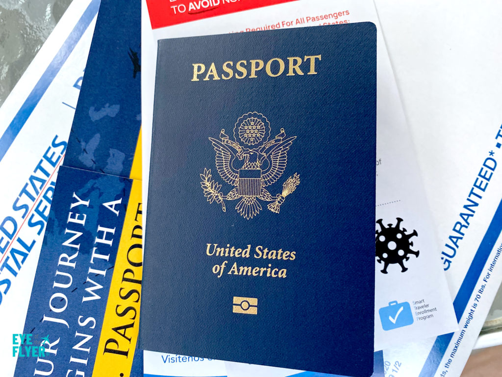 A renewed United States passport booklet and US Express Mail packaging.