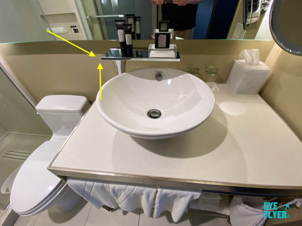 The arrows indicate where you turn off/on the bathroom sink's water in the bathroom inside a W New York - Times Square king bed room