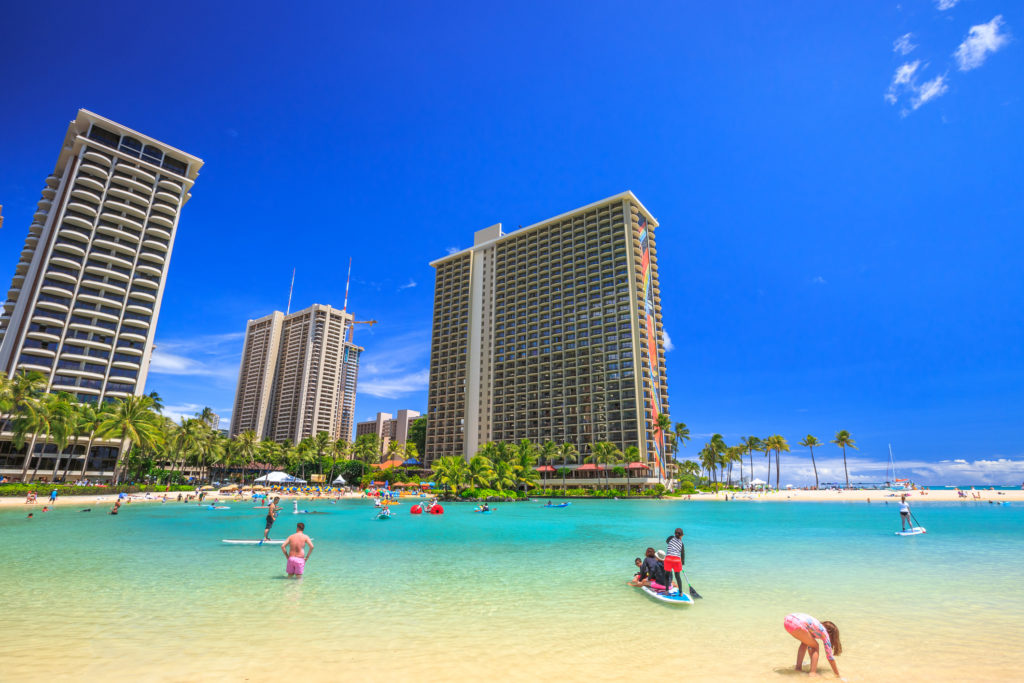 Waikiki, Oahu, Hawaii, USA - August 18, 2016: Hilton Hawaiian Village to the left of Duke Kahanamoku Beach. The beach is one of more popular of Waikiki Beaches because it offers a swimming area protected.