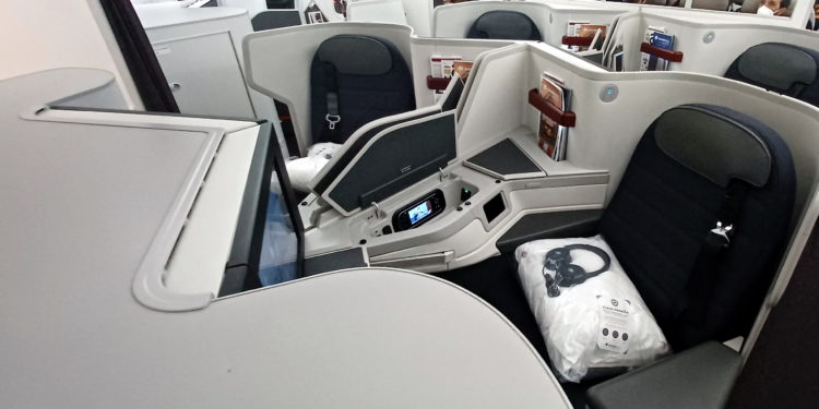 a seat with a screen and a television