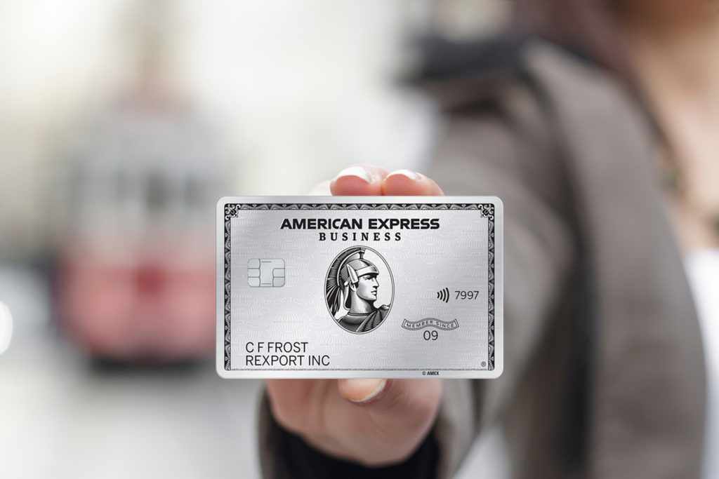 A business person holds The Business Platinum Card® from American Express
