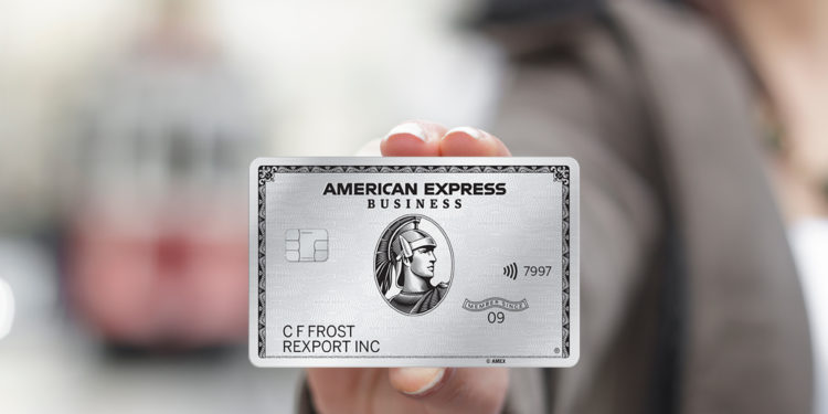A business person holds The Business Platinum Card® from American Express