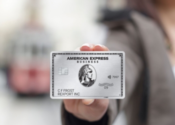 A business person holds The Business Platinum Card® from American Express