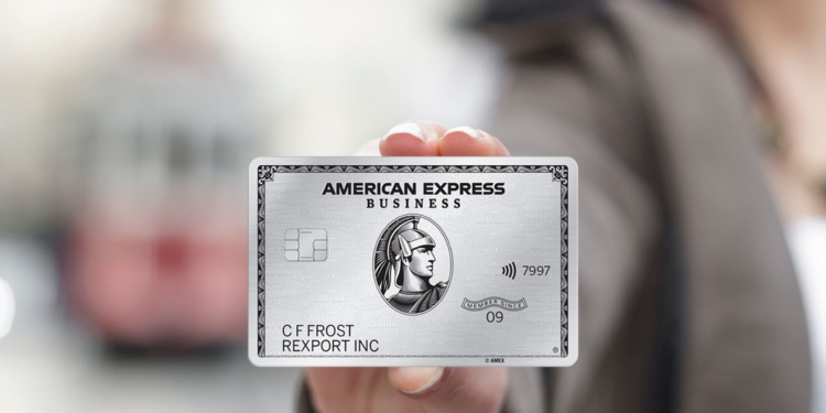 A business person holds The Business Platinum Card® from American Express
