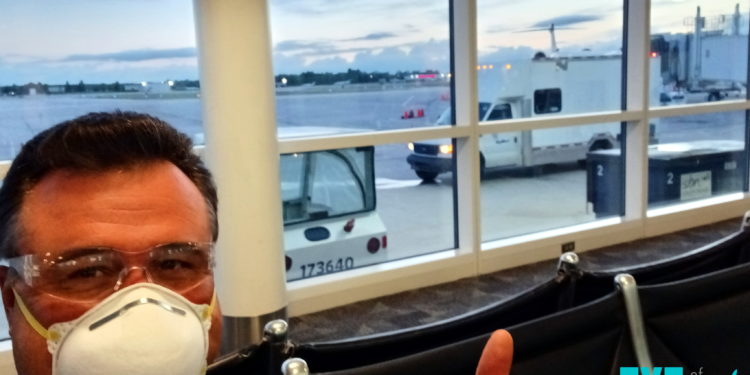 a man wearing a mask and sitting in a chair