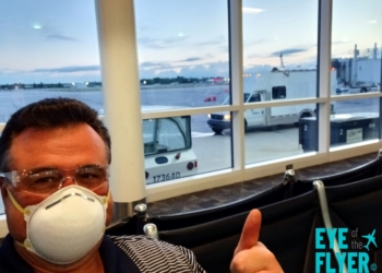 a man wearing a mask and sitting in a chair