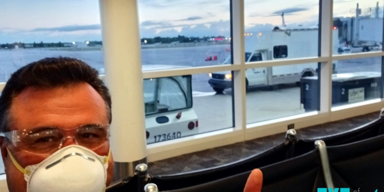 a man wearing a mask and sitting in a chair