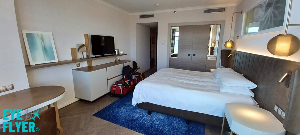 a room with a bed and luggage