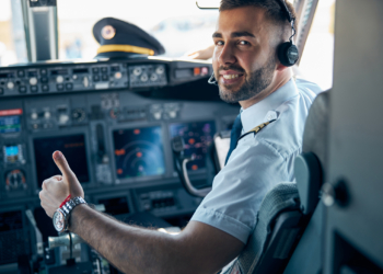 Airline pilot posing in cockpit