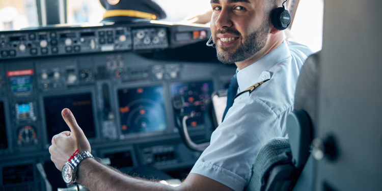 Airline pilot posing in cockpit