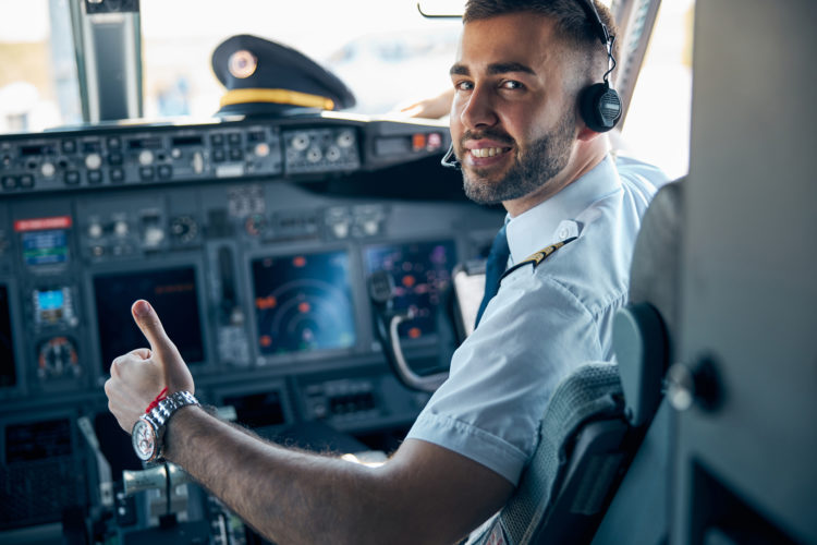 Airline pilot posing in cockpit