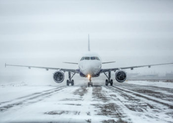 Airliner on a runway in snowy weather, a blizzard.