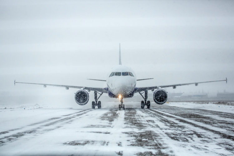 Airliner on a runway in snowy weather, a blizzard.