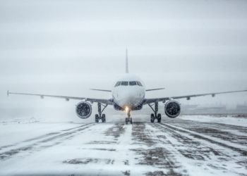 Airliner on a runway in snowy weather, a blizzard.