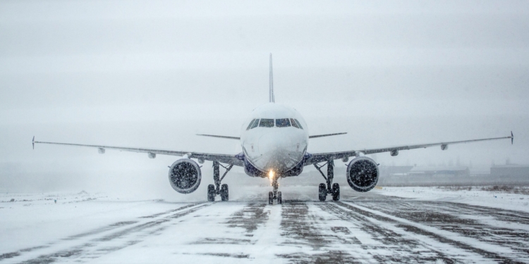 Airliner on a runway in snowy weather, a blizzard.