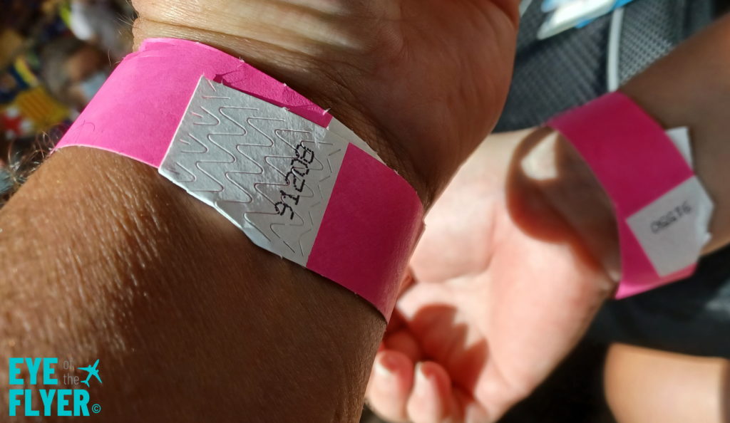 a wrist with a pink band