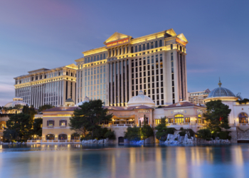 Luxurious hotel Caesars Palace at twilight, located at the Paradise area in the Las Vegas Strip, as seen over the Bellagio Lake.