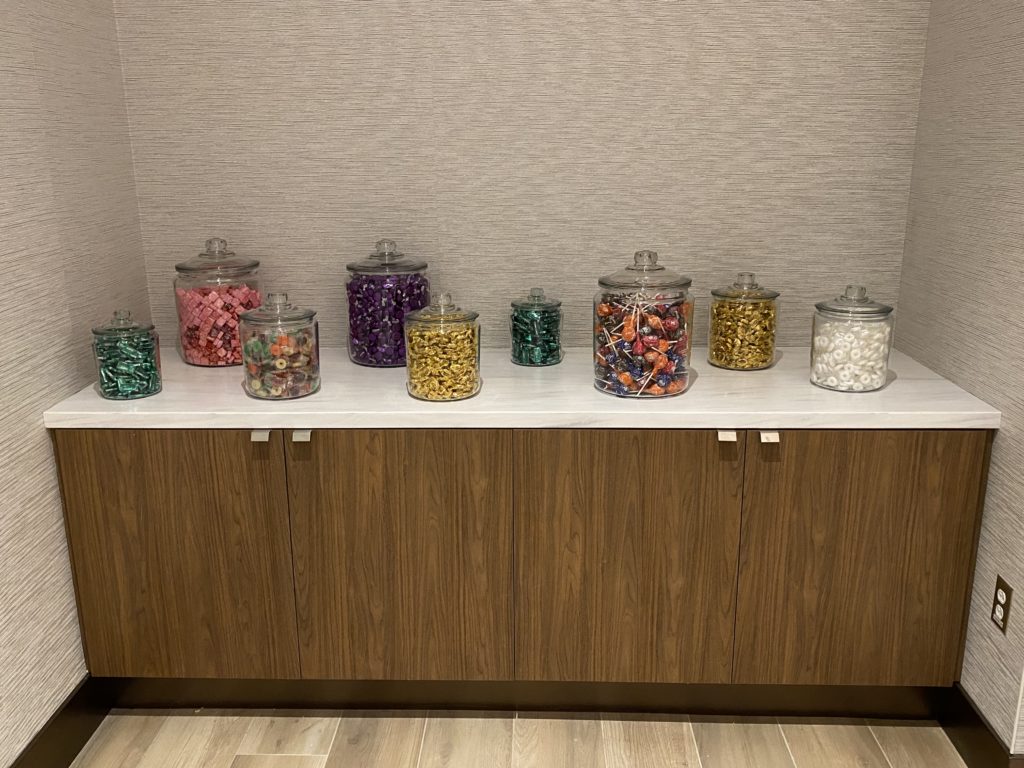 a group of glass containers with different colored candies