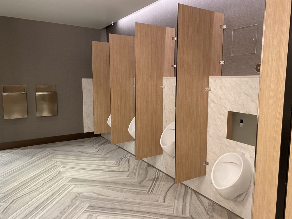 a bathroom with several urinals