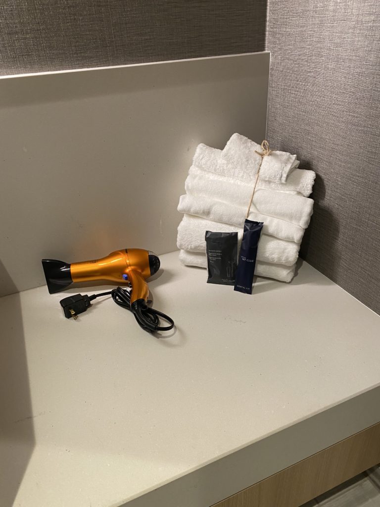 a hair dryer and towels on a counter