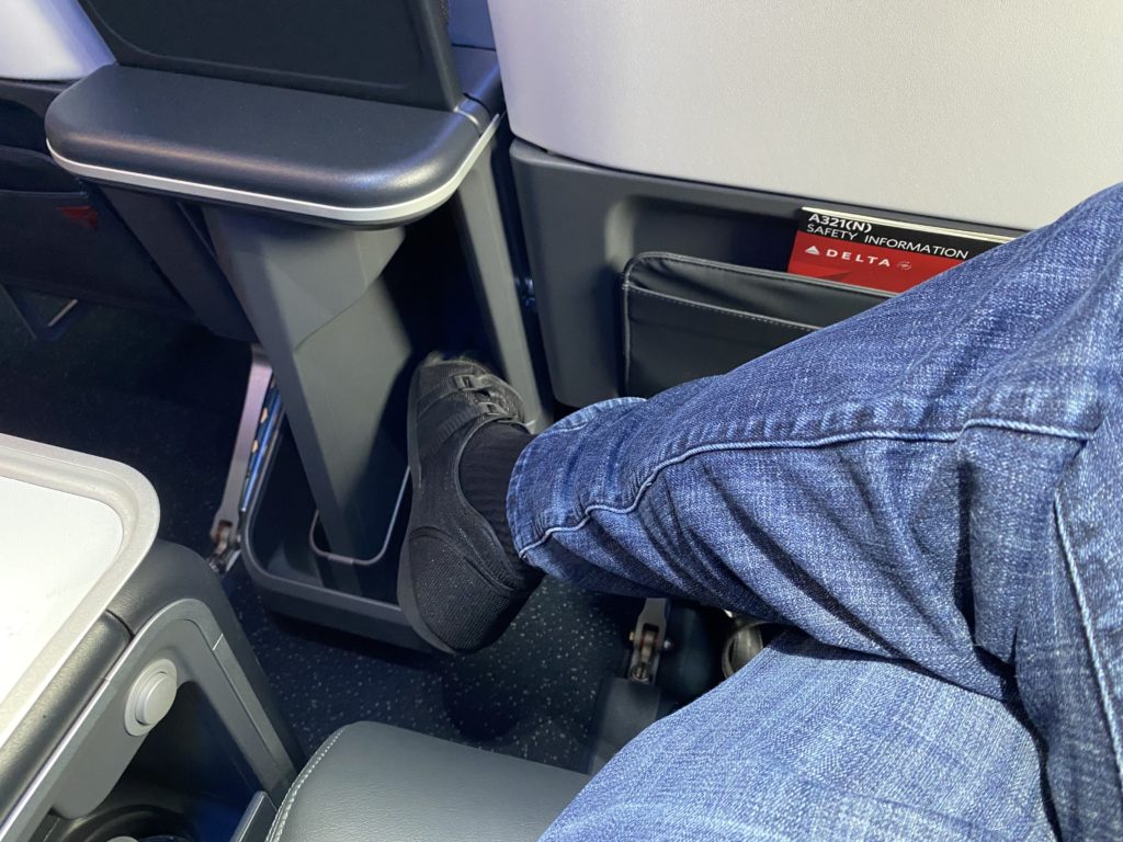 a person's leg in a pocket in an airplane