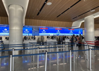 people standing in a line at an airport
