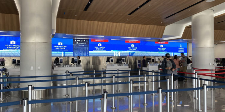 people standing in a line at an airport